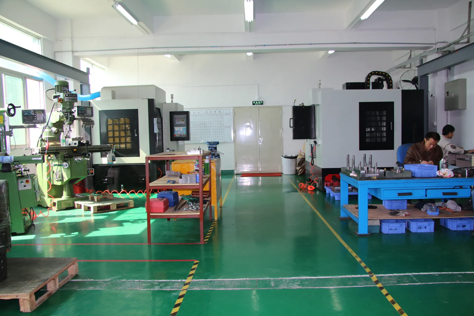 Clean CNC mold manufacturing workshop with precision machining equipment