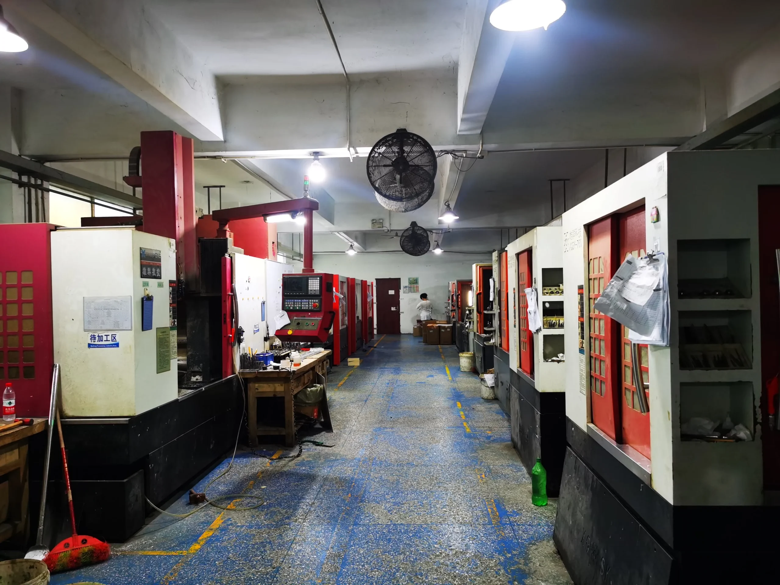 Injection mold tooling workshop with CNC milling machines and manual mold fitting stations
