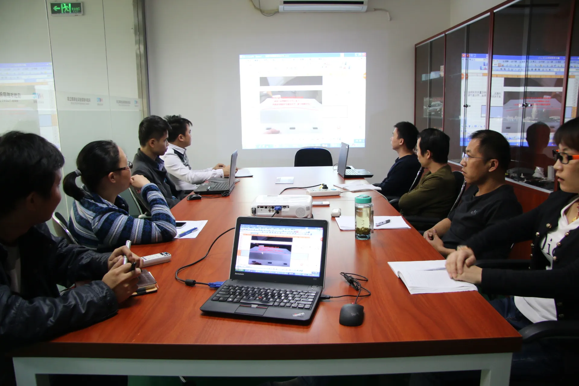 Engineering team reviewing project requirements and technical documents during a product development meeting